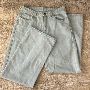 Light wash jeans with butterfly design on the back.